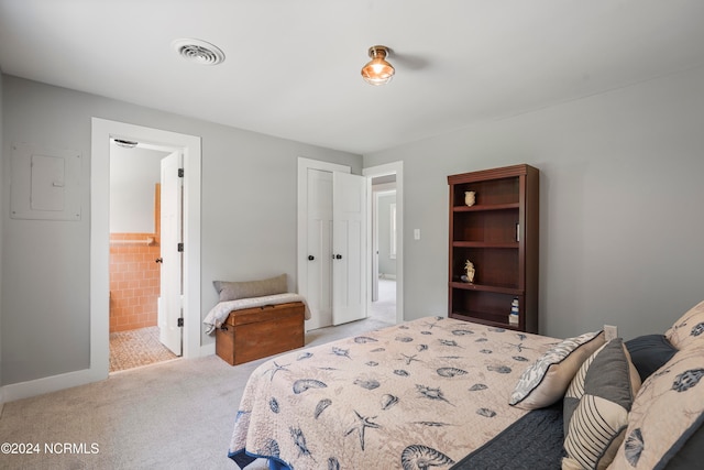 bedroom featuring light colored carpet, connected bathroom, and electric panel