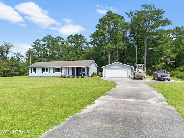 single story home with an outdoor structure, a garage, and a front yard