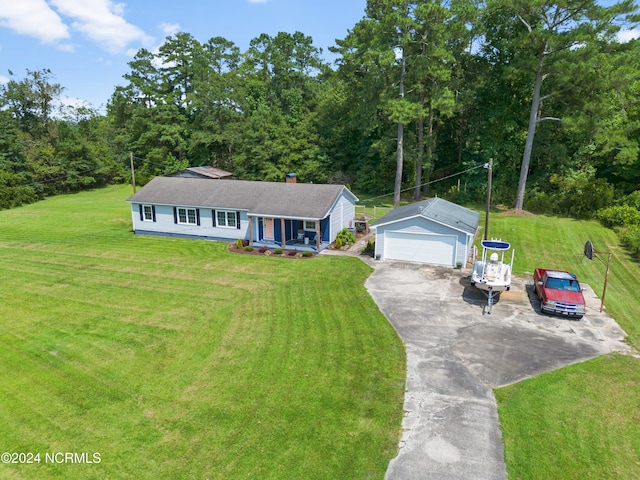 view of front of home with a front yard and an outbuilding