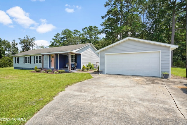 ranch-style home featuring an outbuilding, a garage, and a front yard