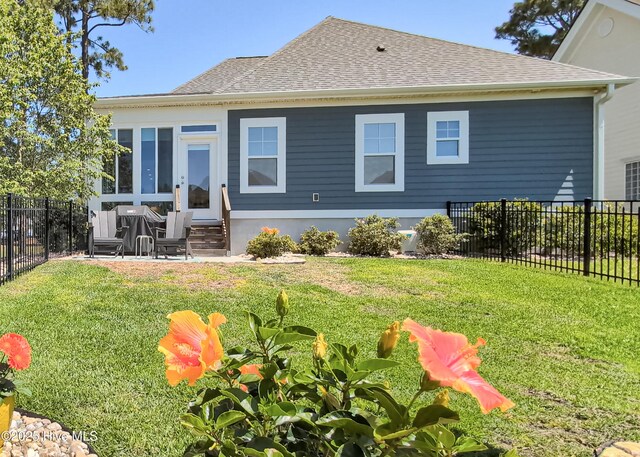 600 Planters Ridge Dr, Sunset Beach, NC 28468 - rear view of property featuring a fenced backyard, entry steps, a yard, and roof with shingles