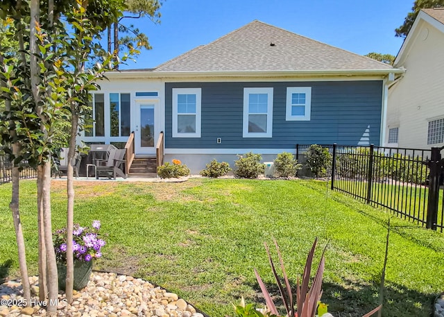 600 Planters Ridge Dr, Sunset Beach, NC 28468 - rear view of property featuring a lawn, roof with shingles, fence, and entry steps