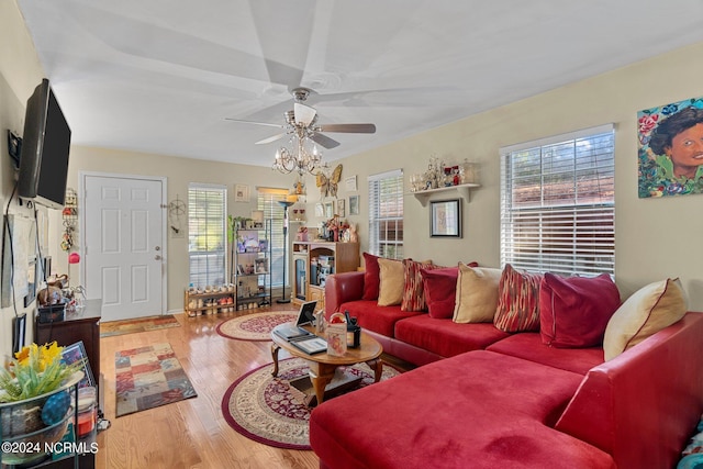 living area featuring a healthy amount of sunlight, ceiling fan, and wood finished floors