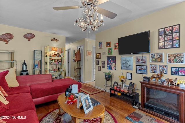 living area with a ceiling fan and wood finished floors