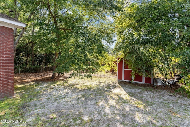 view of yard featuring a shed and an outbuilding