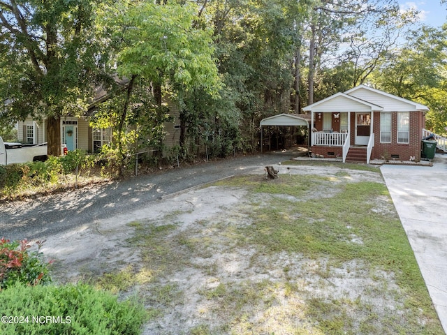 view of yard featuring covered porch and driveway