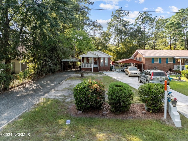 view of front of property with driveway, a front lawn, and brick siding