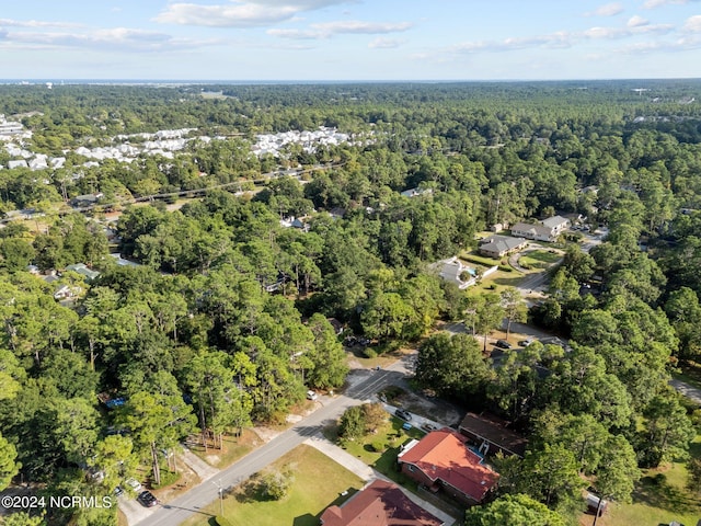 drone / aerial view featuring a wooded view