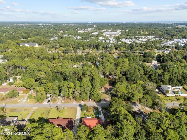 bird's eye view featuring a wooded view