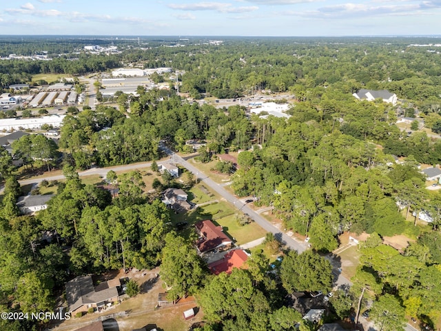 birds eye view of property featuring a view of trees