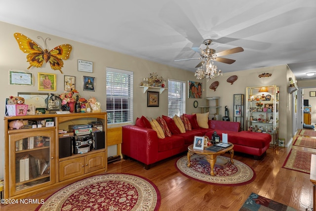 living area with a ceiling fan and wood finished floors