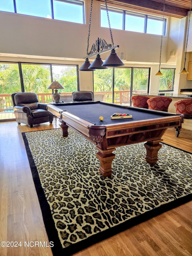7422 Sea Lilly Ln, Wilmington, NC 28409 - playroom featuring pool table, plenty of natural light, wood finished floors, and a towering ceiling