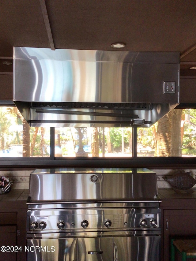 7422 Sea Lilly Ln, Wilmington, NC 28409 - room details featuring dark countertops, decorative backsplash, and extractor fan