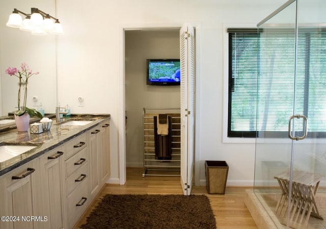 7422 Sea Lilly Ln, Wilmington, NC 28409 - bathroom with a sink, baseboards, double vanity, and wood finished floors