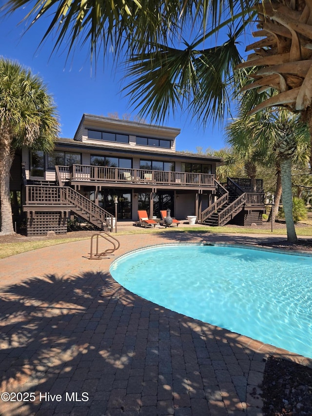 7422 Sea Lilly Ln, Wilmington, NC 28409 - outdoor pool featuring stairway, a wooden deck, and a patio area