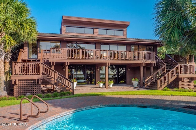 exterior space with a wooden deck and a patio area