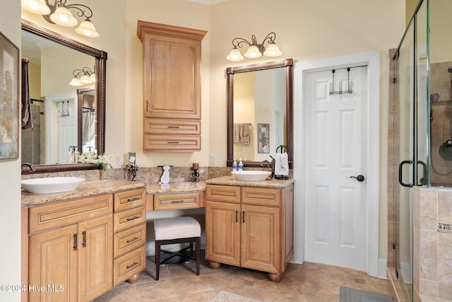 bathroom with vanity and a shower with shower door