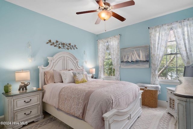 bedroom with vaulted ceiling, light colored carpet, and a ceiling fan