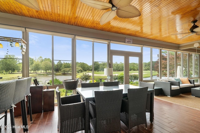 sunroom / solarium featuring a wealth of natural light, a water view, and ceiling fan