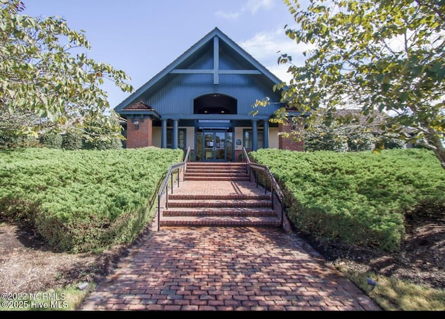 view of front of home featuring a porch and brick siding
