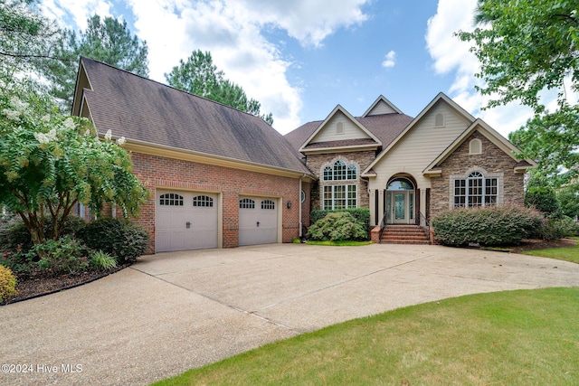 traditional home featuring concrete driveway, a shingled roof, brick siding, and a garage