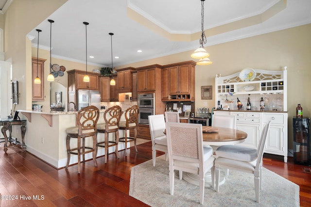 dining area featuring ornamental molding, a raised ceiling, beverage cooler, sink, and dark hardwood / wood-style floors