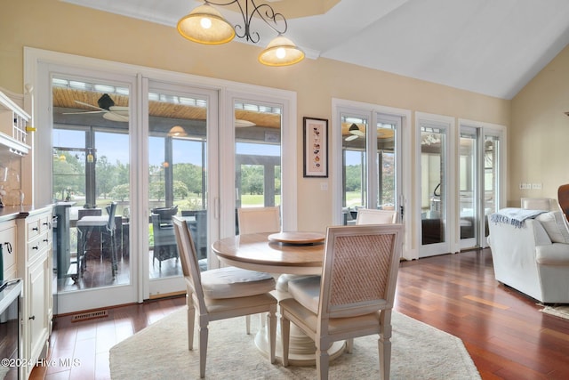 kitchen featuring pendant lighting, a tray ceiling, a sink, decorative backsplash, and appliances with stainless steel finishes