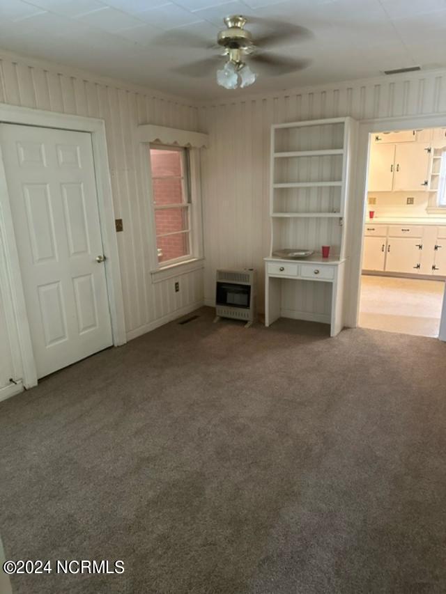 unfurnished bedroom with carpet and multiple windows