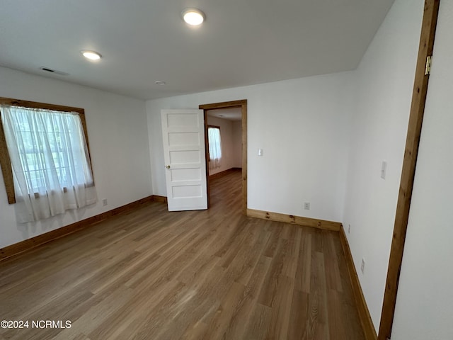 unfurnished bedroom with hardwood / wood-style floors