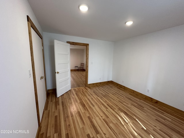 unfurnished bedroom with hardwood / wood-style flooring