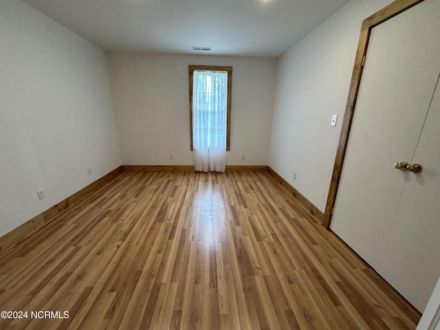 empty room with light hardwood / wood-style floors