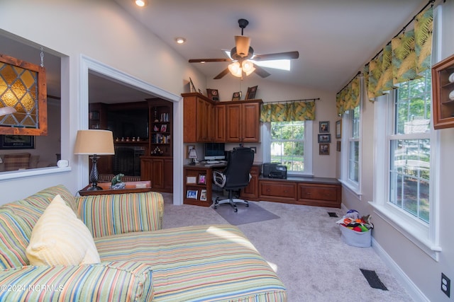 interior space with ceiling fan, carpet flooring, and lofted ceiling