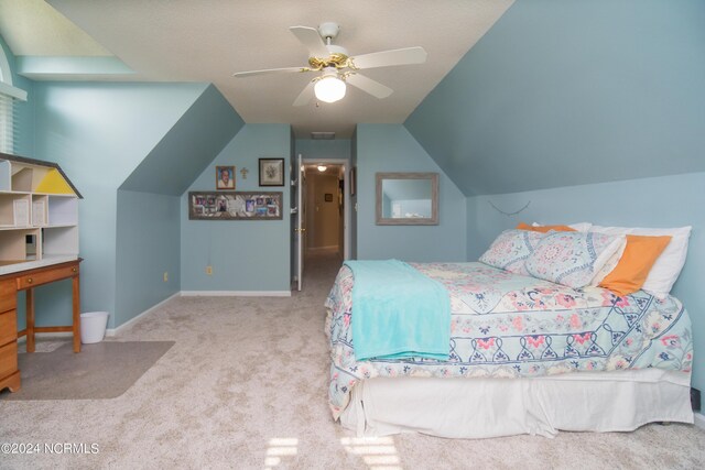 carpeted bedroom with ceiling fan and vaulted ceiling