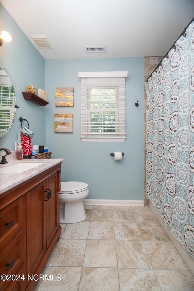 bathroom featuring tile patterned flooring, vanity, and toilet