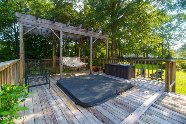 wooden terrace featuring a pergola and a covered hot tub