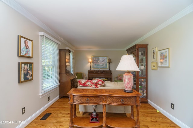 dining room featuring crown molding and light wood-type flooring