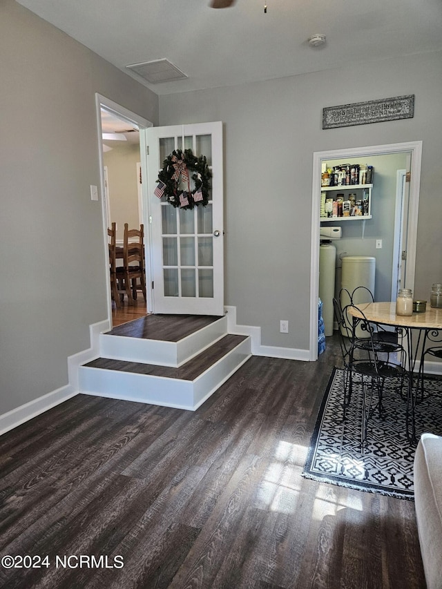 dining space featuring dark wood-type flooring, visible vents, and baseboards