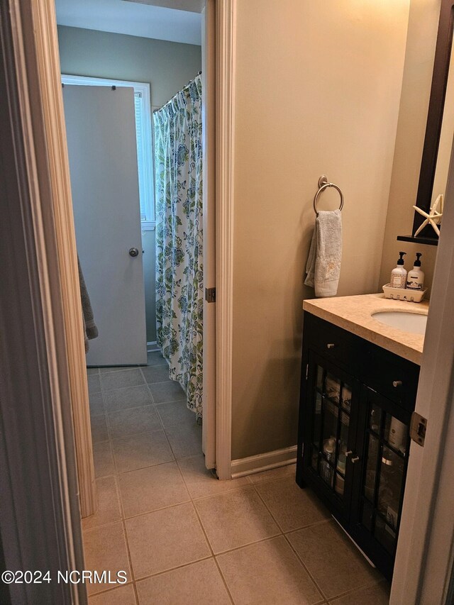 bathroom with tile patterned floors and vanity