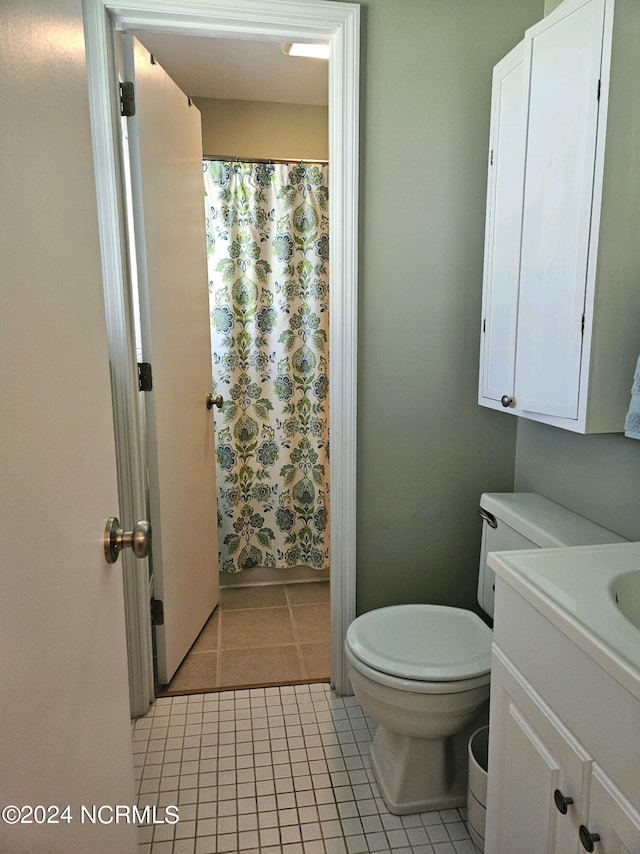 bathroom featuring tile patterned flooring, vanity, and toilet