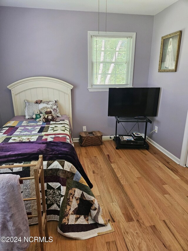 bedroom with hardwood / wood-style flooring