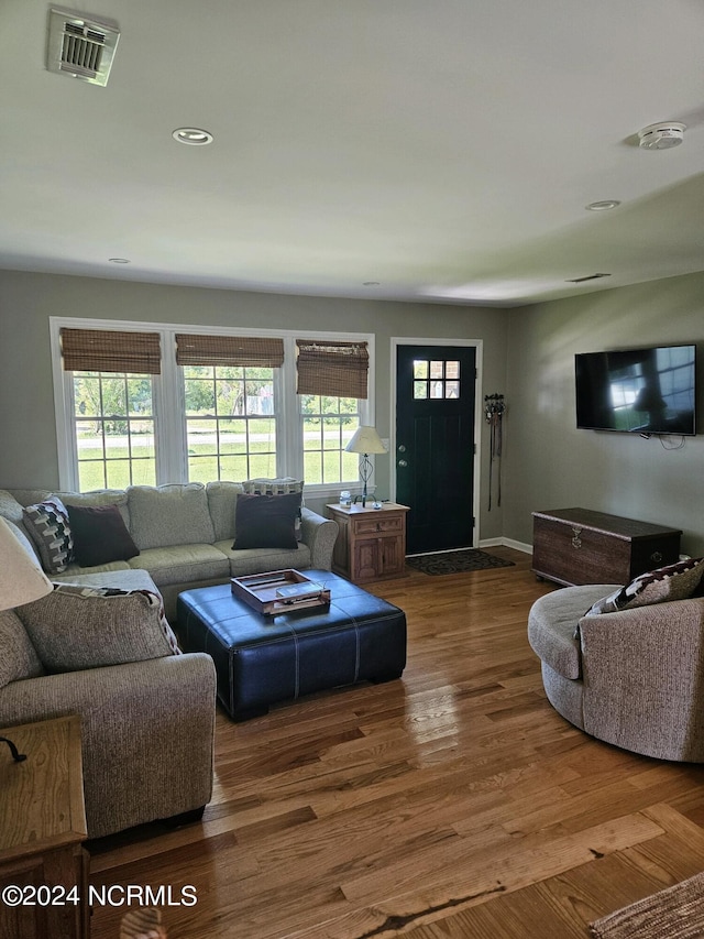 living room featuring dark wood-style floors, recessed lighting, visible vents, and a healthy amount of sunlight