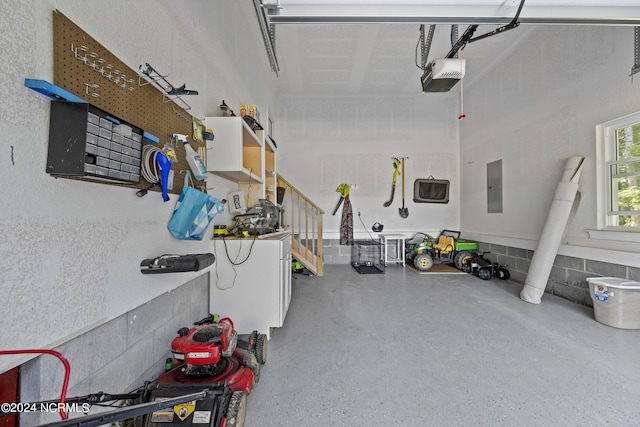 garage with electric panel and a garage door opener