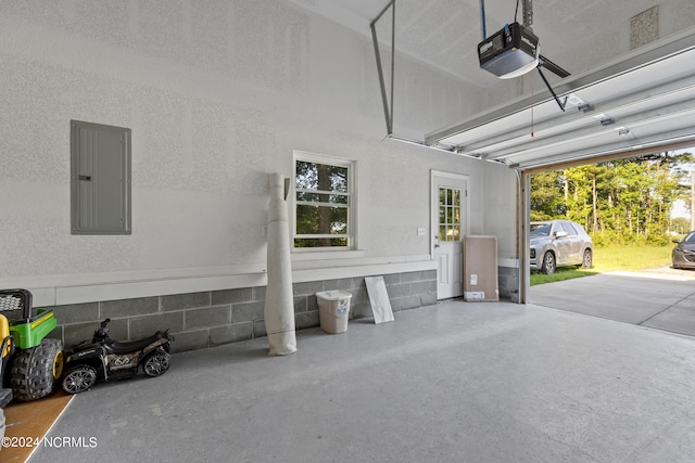 garage featuring electric panel and a garage door opener