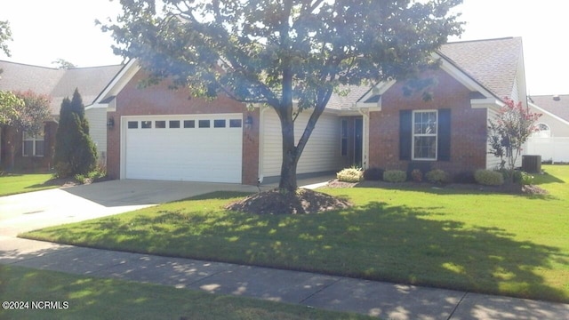 view of front facade with a garage, a front lawn, and central AC