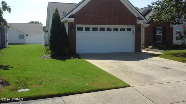 view of front of property with a garage and a front lawn