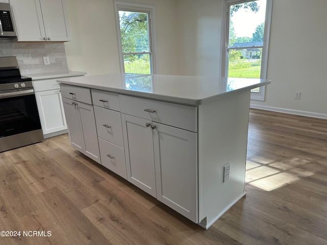 kitchen with stainless steel appliances, light hardwood / wood-style floors, and a healthy amount of sunlight