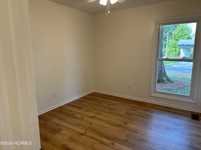 unfurnished room with ceiling fan and wood-type flooring