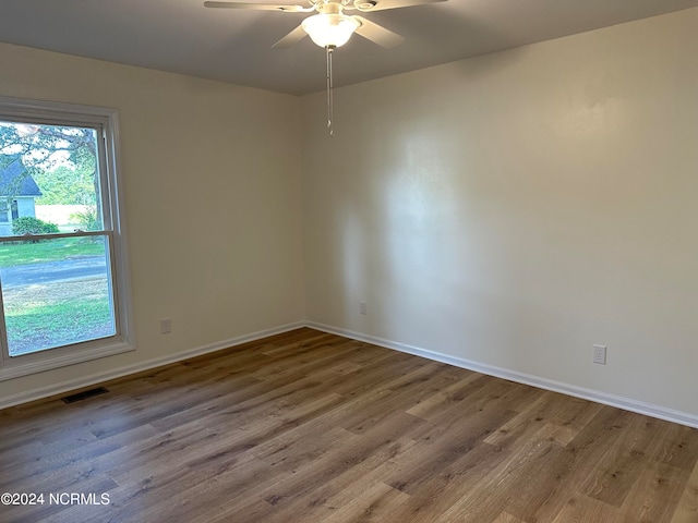 unfurnished room with hardwood / wood-style flooring and ceiling fan