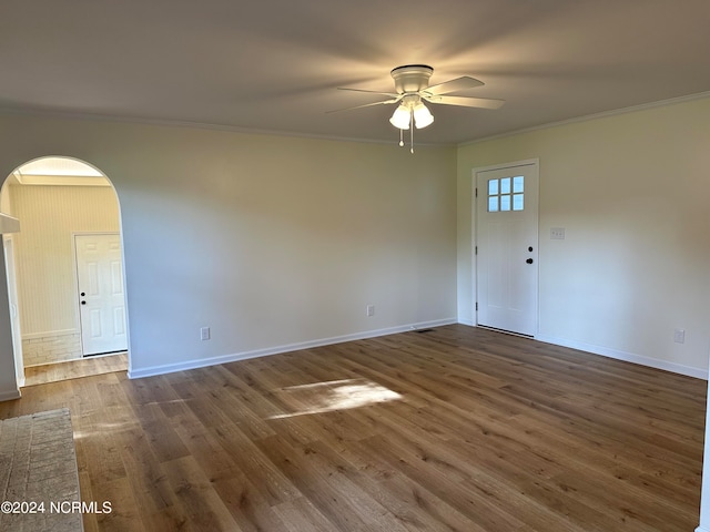 spare room featuring ornamental molding, ceiling fan, and dark hardwood / wood-style floors