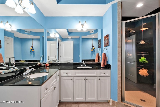 bathroom with vanity, tile patterned floors, and a shower with door